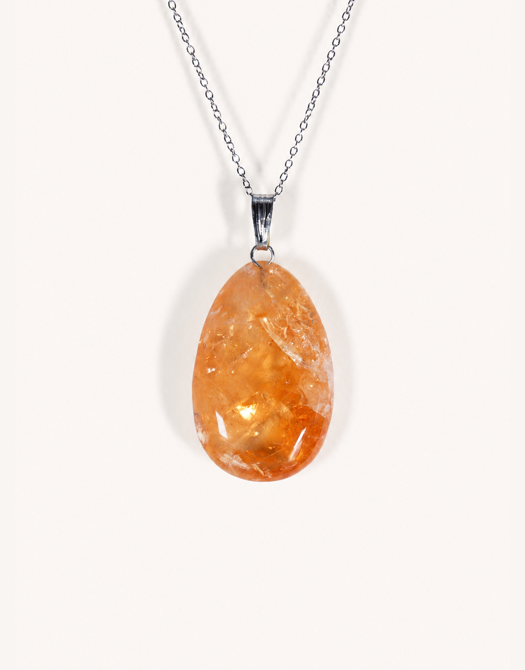 A Natural Heat-Treated Citrine Pendant displaying rich golden amber hues on an 18-inch stainless steel chain.