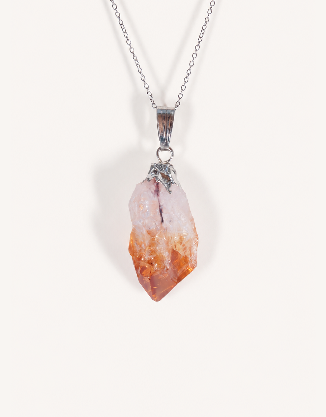 A Natural Raw Citrine Point Pendant showcasing a rough amber-orange and white crystal point on an 18-inch stainless steel chain.
