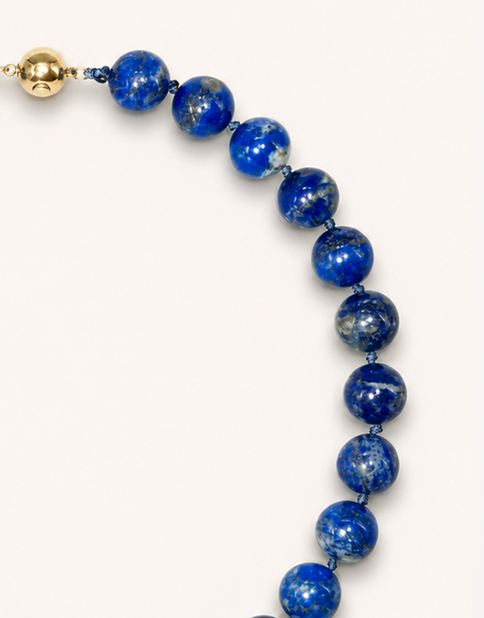 A 16-inch Natural Lapis Lazuli Choker displaying rich royal blue 12mm beads with golden pyrite flecks.
