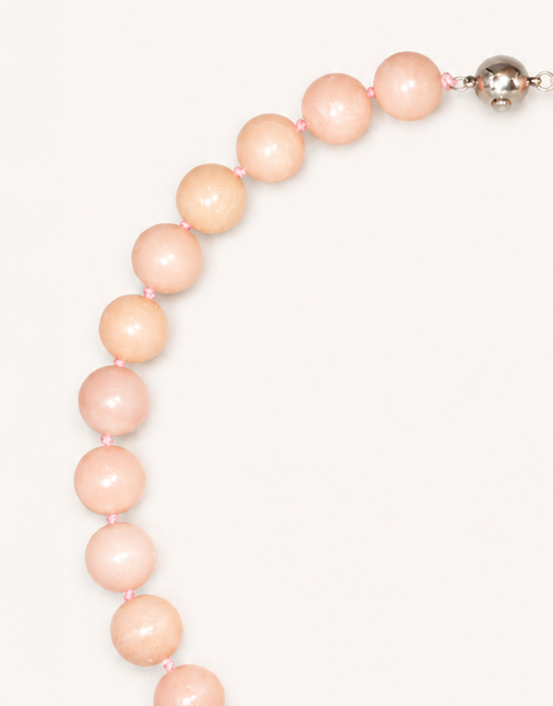 A 16-inch Natural Pink Opal Choker crafted with smooth 12mm beads in shades of pastel pink and ivory.
