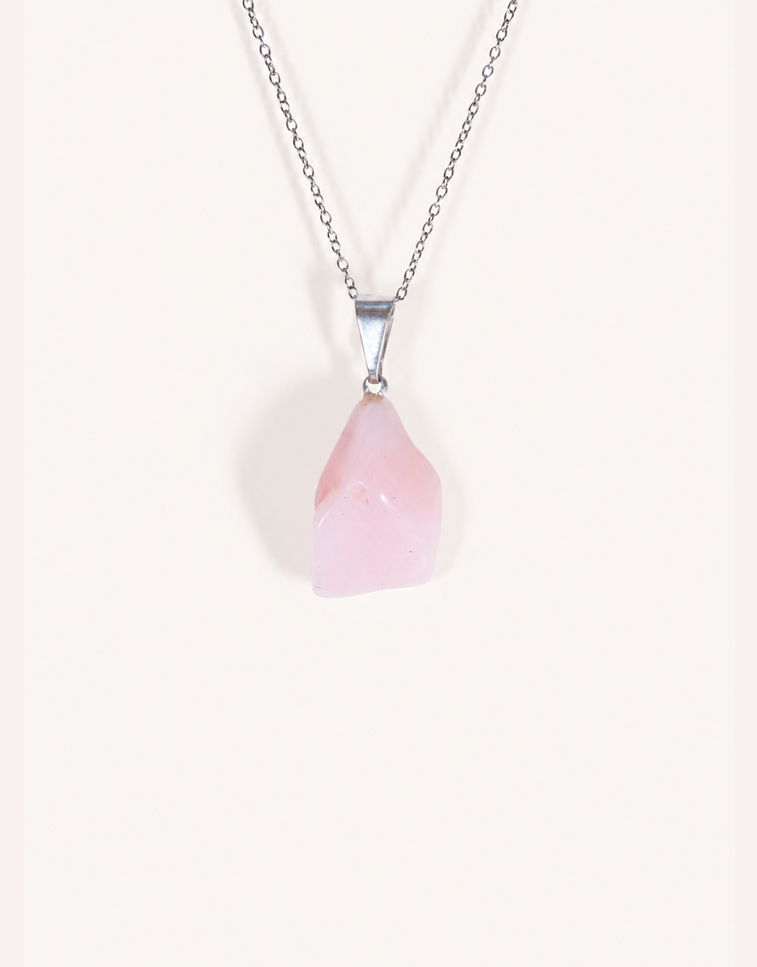 A Natural Pink Opal Pendant featuring a smooth pastel pink tumbled stone on an 18-inch stainless steel chain.