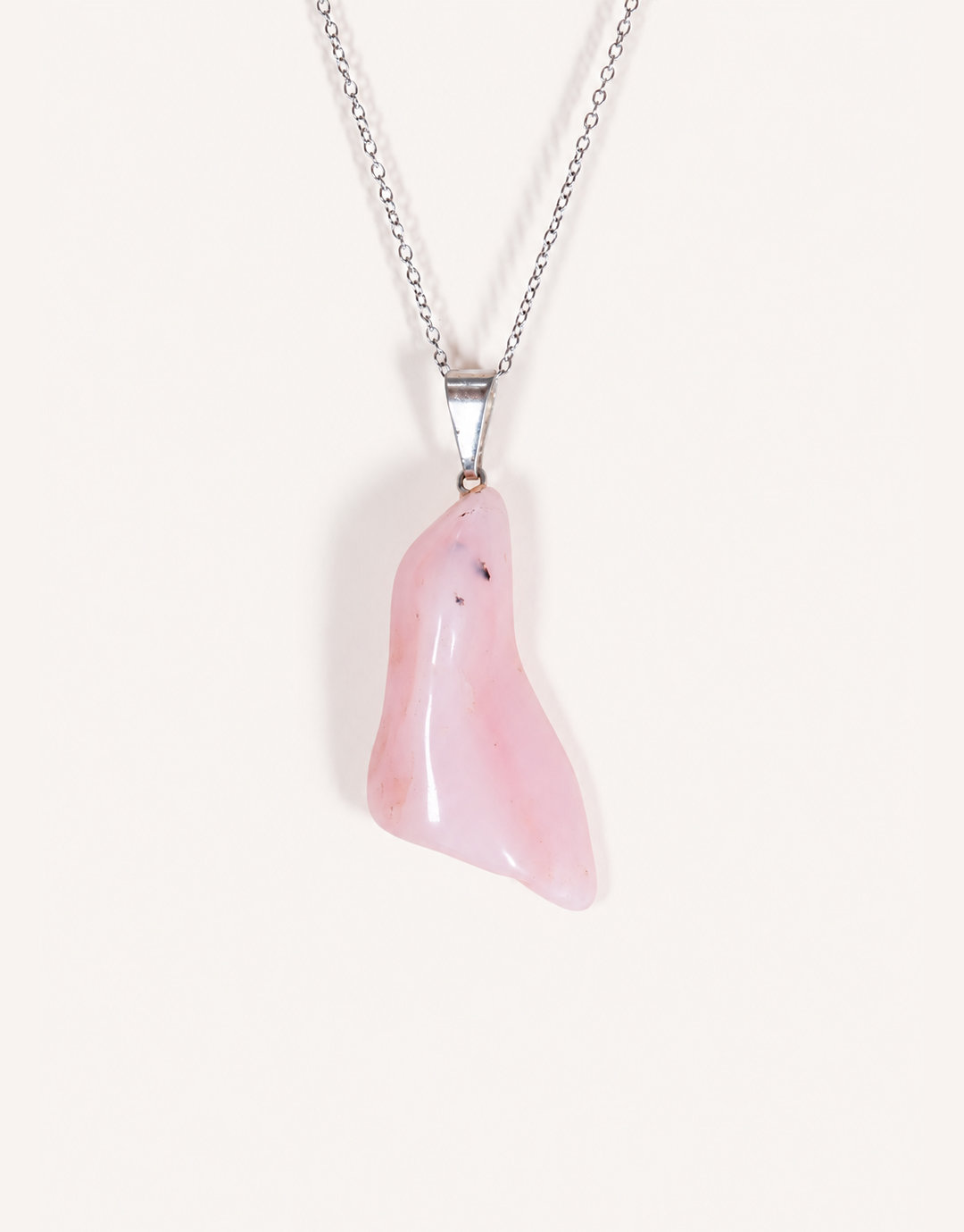 A Natural Pink Opal Pendant featuring a smooth pastel pink tumbled stone on an 18-inch stainless steel chain.
