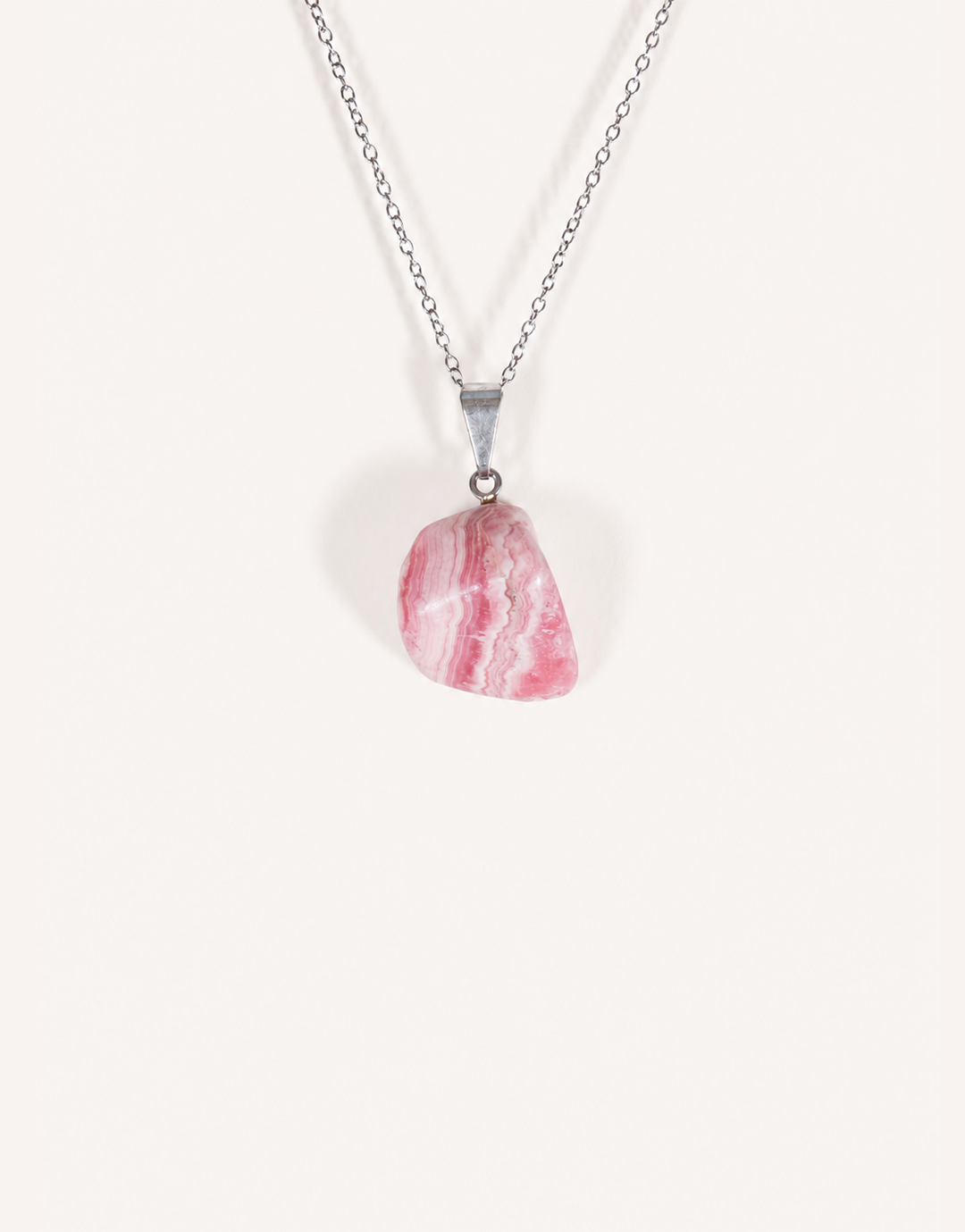 A Natural Rhodochrosite Pendant featuring a smooth pink stone with white banded ribbons on an 18-inch stainless steel chain.