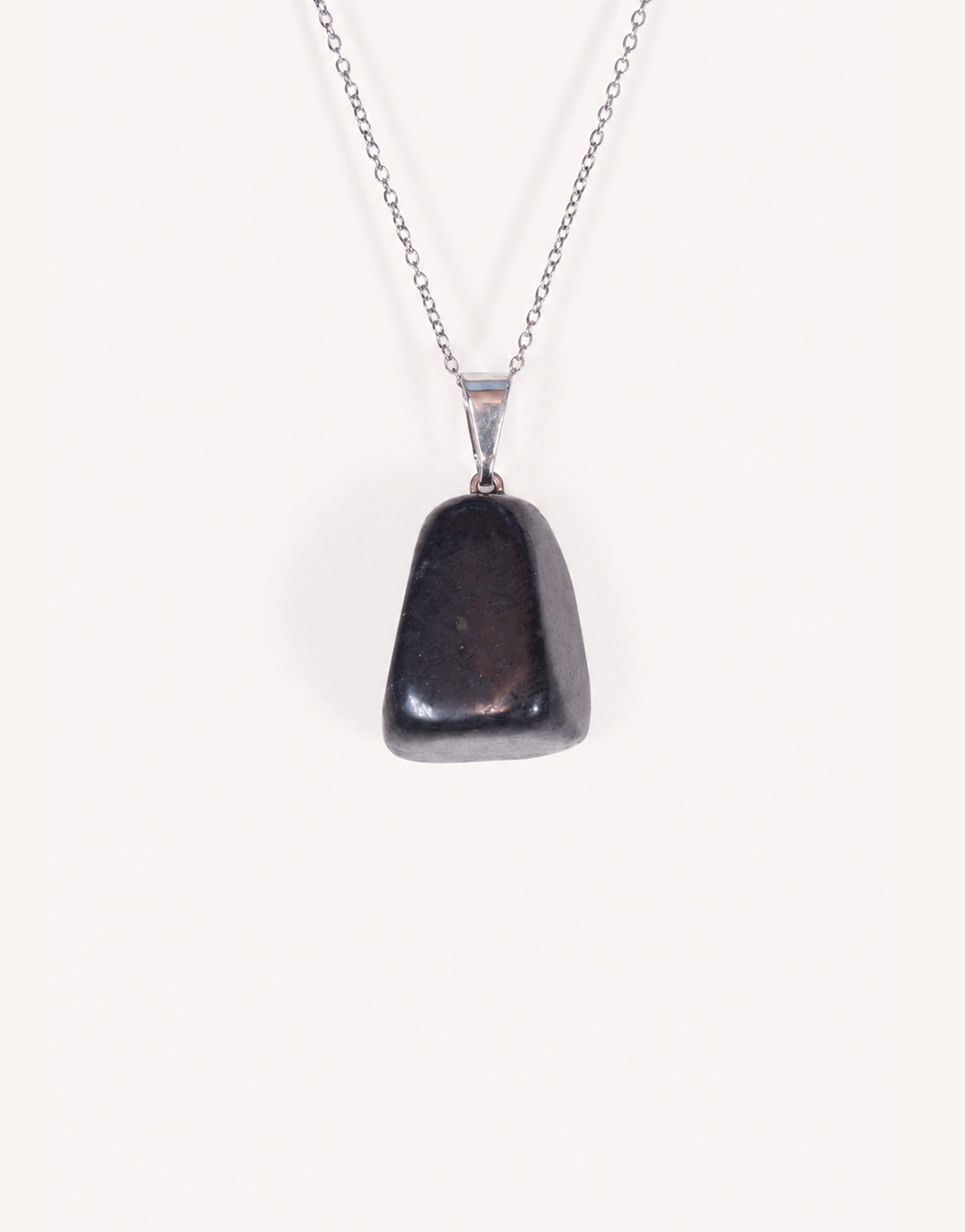 A Natural Shungite Pendant featuring a smooth graphite-black tumbled stone on an 18-inch stainless steel chain.