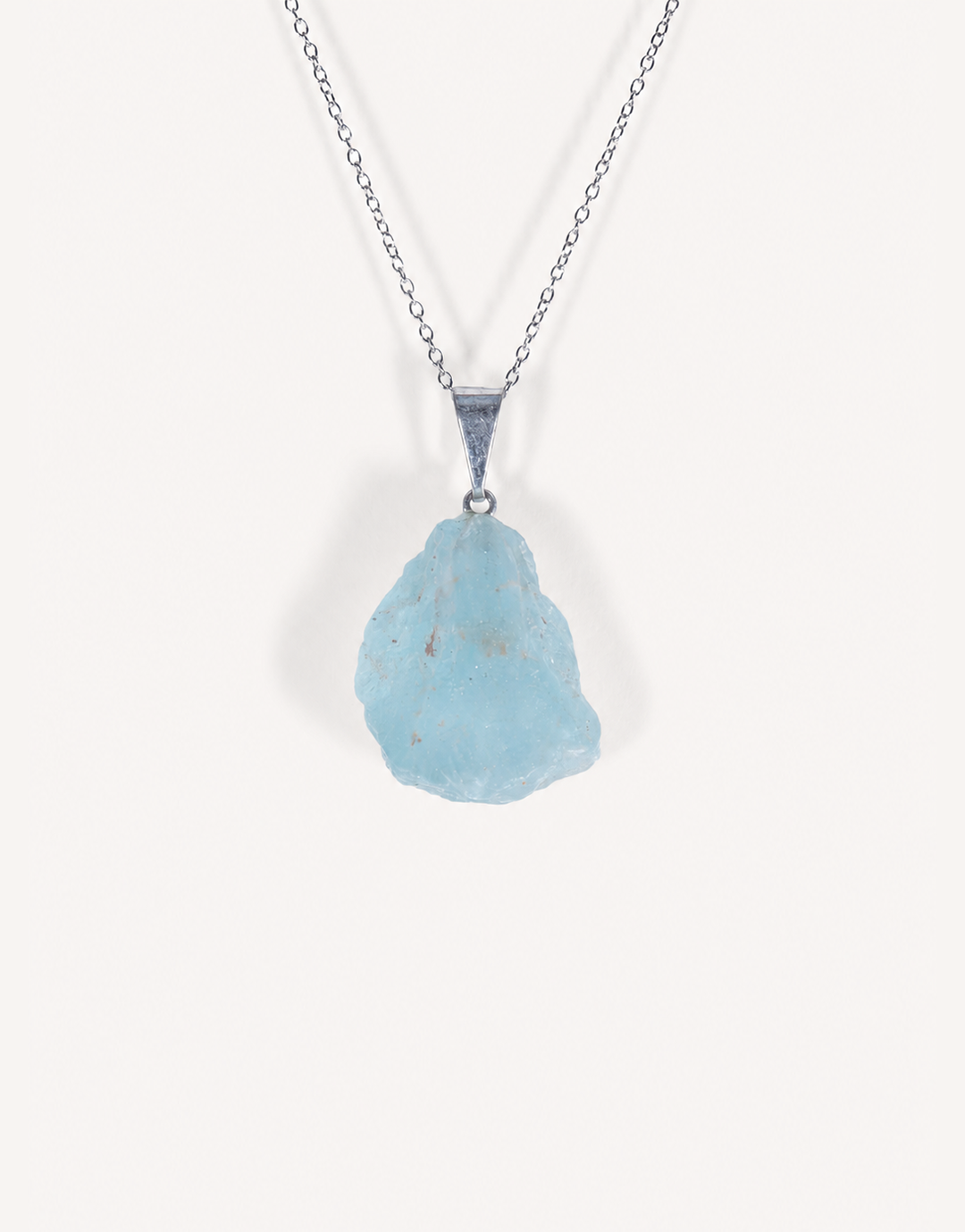 A Natural Blue Topaz Pendant displaying smooth sky-blue clarity on an 18-inch stainless steel chain.