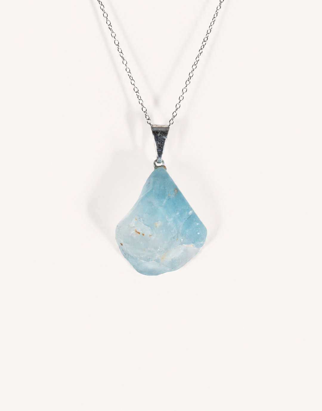 A Natural Blue Topaz Pendant displaying smooth sky-blue clarity on an 18-inch stainless steel chain.