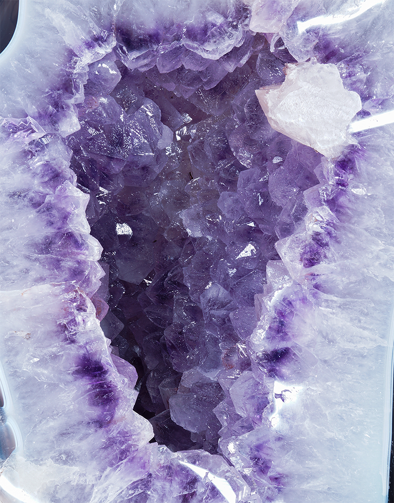 An 11 kg Uruguayan Amethyst Freeform Sculpture standing 35 cm tall with a polished agate border surrounding a purple crystal cavity.