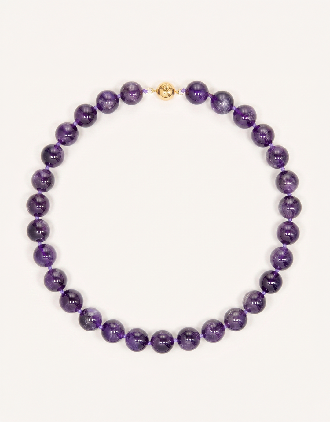 A 16-inch Natural Amethyst Necklace featuring polished 12mm beads in rich violet and lavender shades.