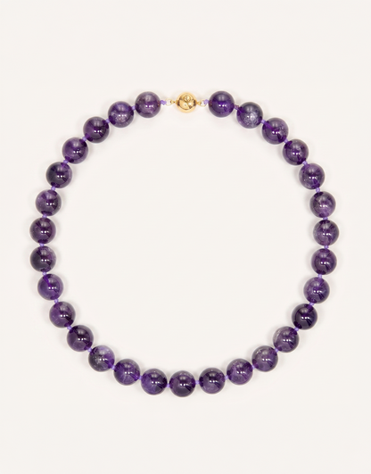 A 16-inch Natural Amethyst Necklace featuring polished 12mm beads in rich violet and lavender shades.