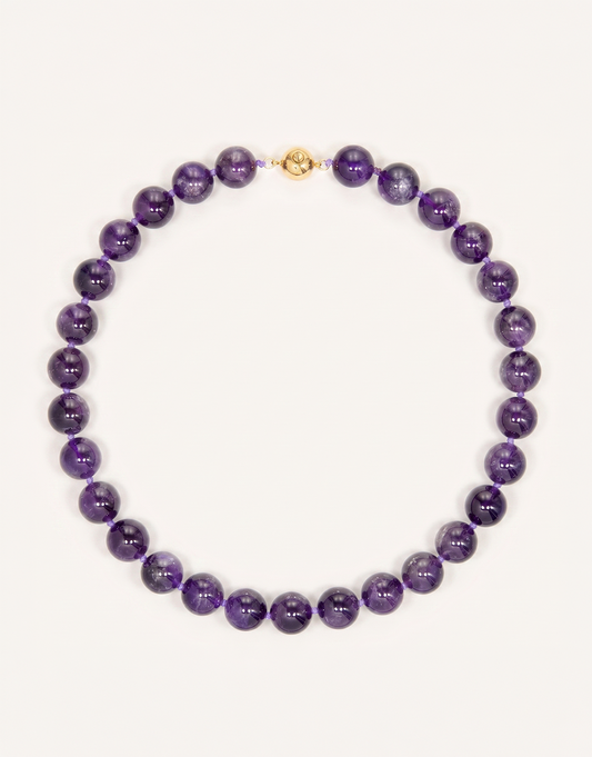 A 16-inch Natural Amethyst Necklace featuring polished 12mm beads in rich violet and lavender shades.