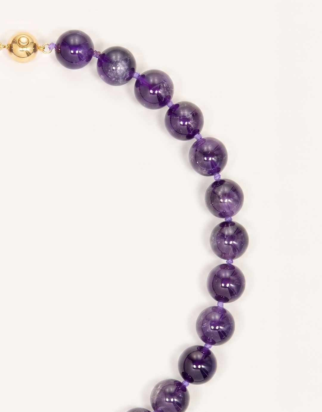 A 16-inch Natural Amethyst Necklace featuring polished 12mm beads in rich violet and lavender shades.