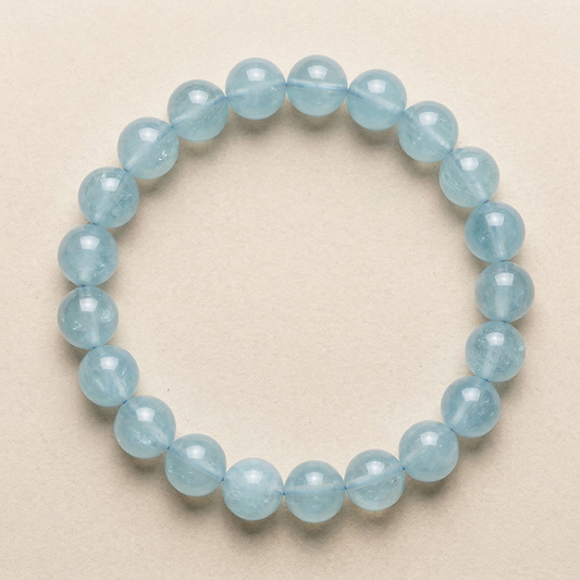 Light blue Aquamarine beaded bracelet on a beige background
