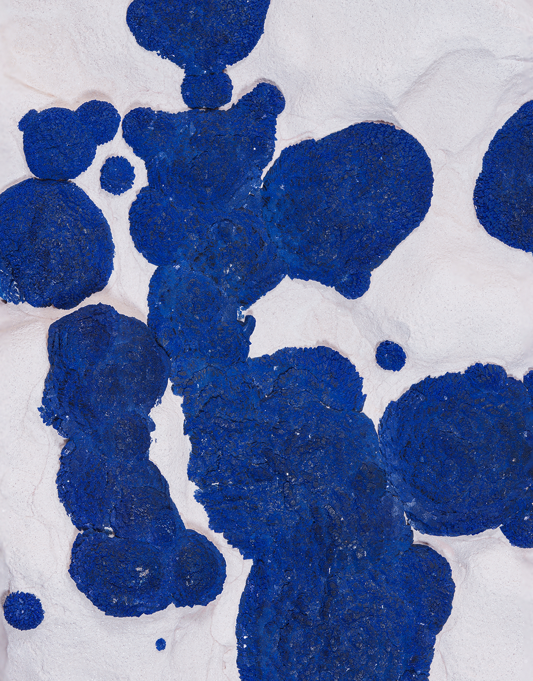 An Azurite on Kaolinite mineral specimen from the Malbunka Mine, Australia, featuring vivid blue azurite clusters on white matrix, mounted on a clear stand.