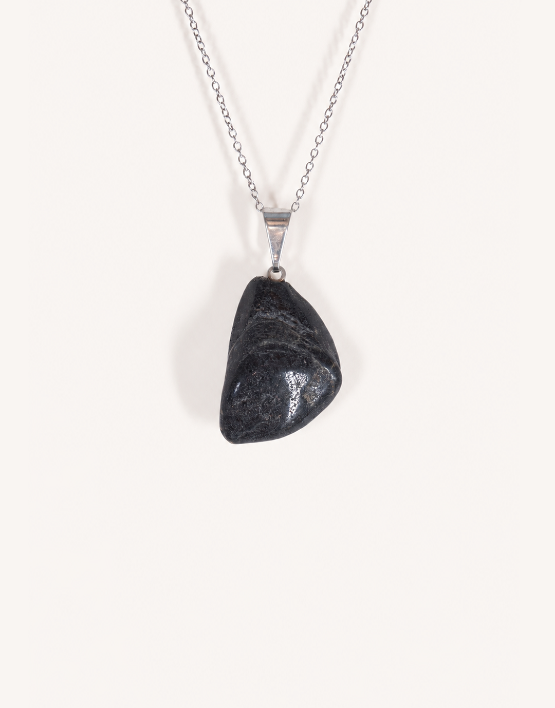 A Natural Black Tourmaline Pendant displaying a smooth, glossy jet-black tumbled stone on an 18-inch stainless steel chain.