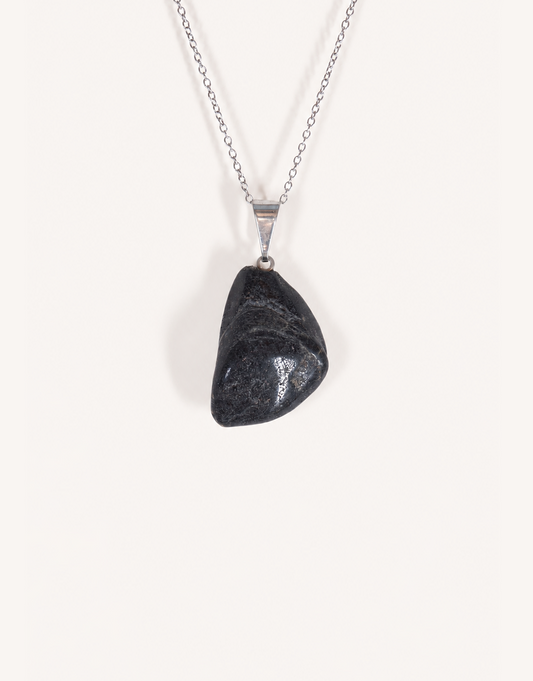 A Natural Black Tourmaline Pendant displaying a smooth, glossy jet-black tumbled stone on an 18-inch stainless steel chain.