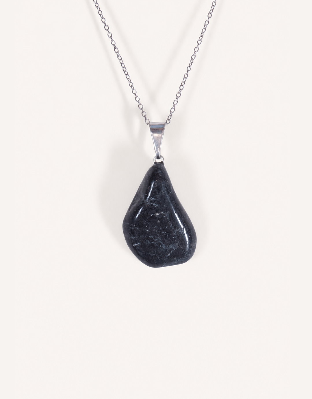 A Natural Black Tourmaline Pendant displaying a smooth, glossy jet-black tumbled stone on an 18-inch stainless steel chain.