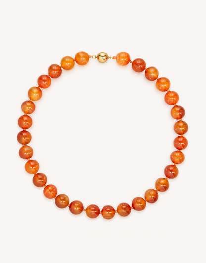 A 16-inch Natural Carnelian Necklace crafted with smooth 12mm beads in glowing shades of burnt orange, amber, and deep crimson.