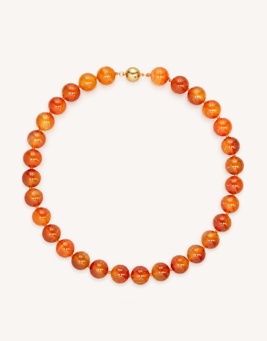 A 16-inch Natural Carnelian Necklace crafted with smooth 12mm beads in glowing shades of burnt orange, amber, and deep crimson.