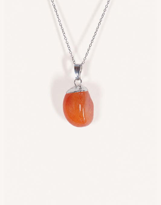 A Natural Carnelian Pendant featuring a smooth, polished orange tumbled stone on an 18-inch stainless steel chain.