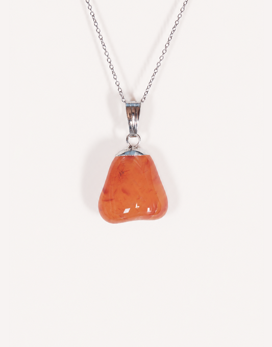 A Natural Carnelian Pendant featuring a smooth, polished orange tumbled stone on an 18-inch stainless steel chain.