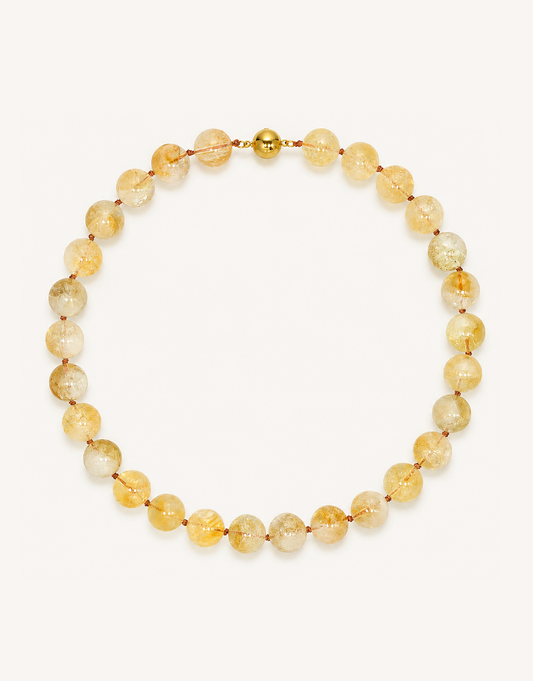 A 16-inch Natural Citrine Necklace crafted with smooth 12mm translucent beads in shades of warm amber, yellow, and honey.
