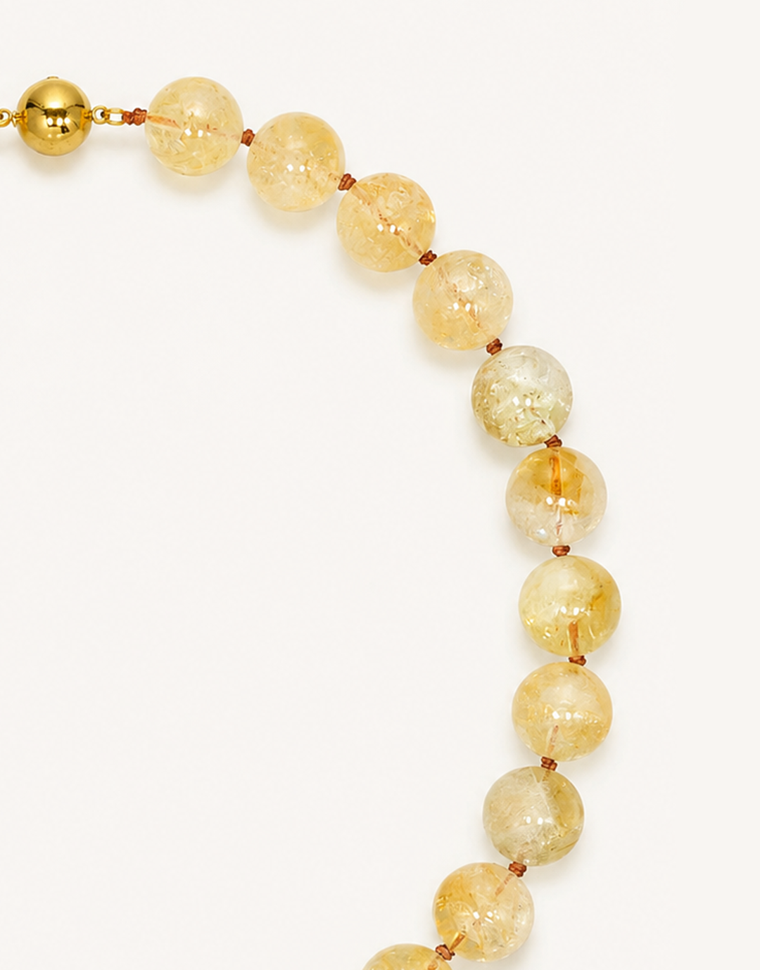 A 16-inch Natural Citrine Necklace crafted with smooth 12mm translucent beads in shades of warm amber, yellow, and honey.