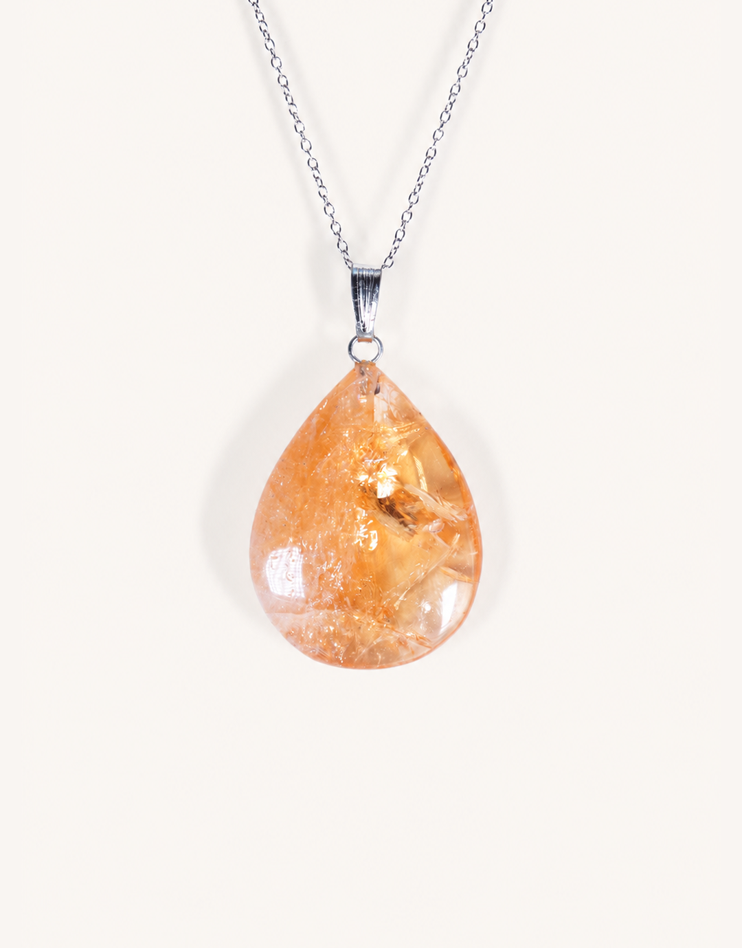 A Natural Heat-Treated Citrine Pendant displaying rich golden amber hues on an 18-inch stainless steel chain.