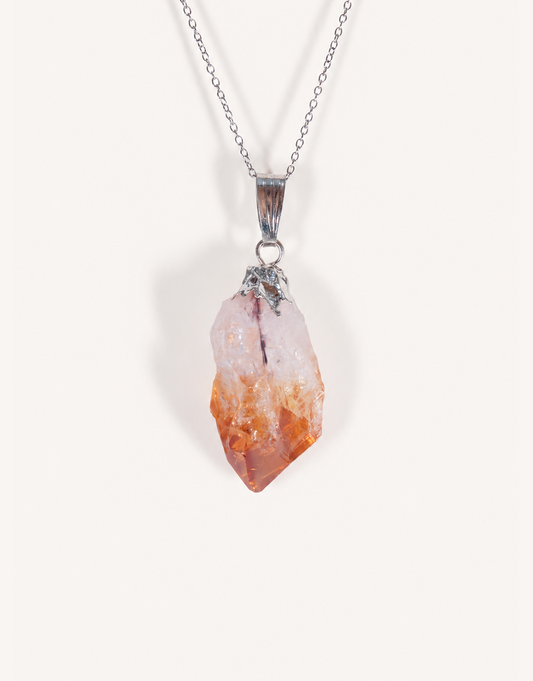 A Natural Raw Citrine Point Pendant showcasing a rough amber-orange and white crystal point on an 18-inch stainless steel chain.