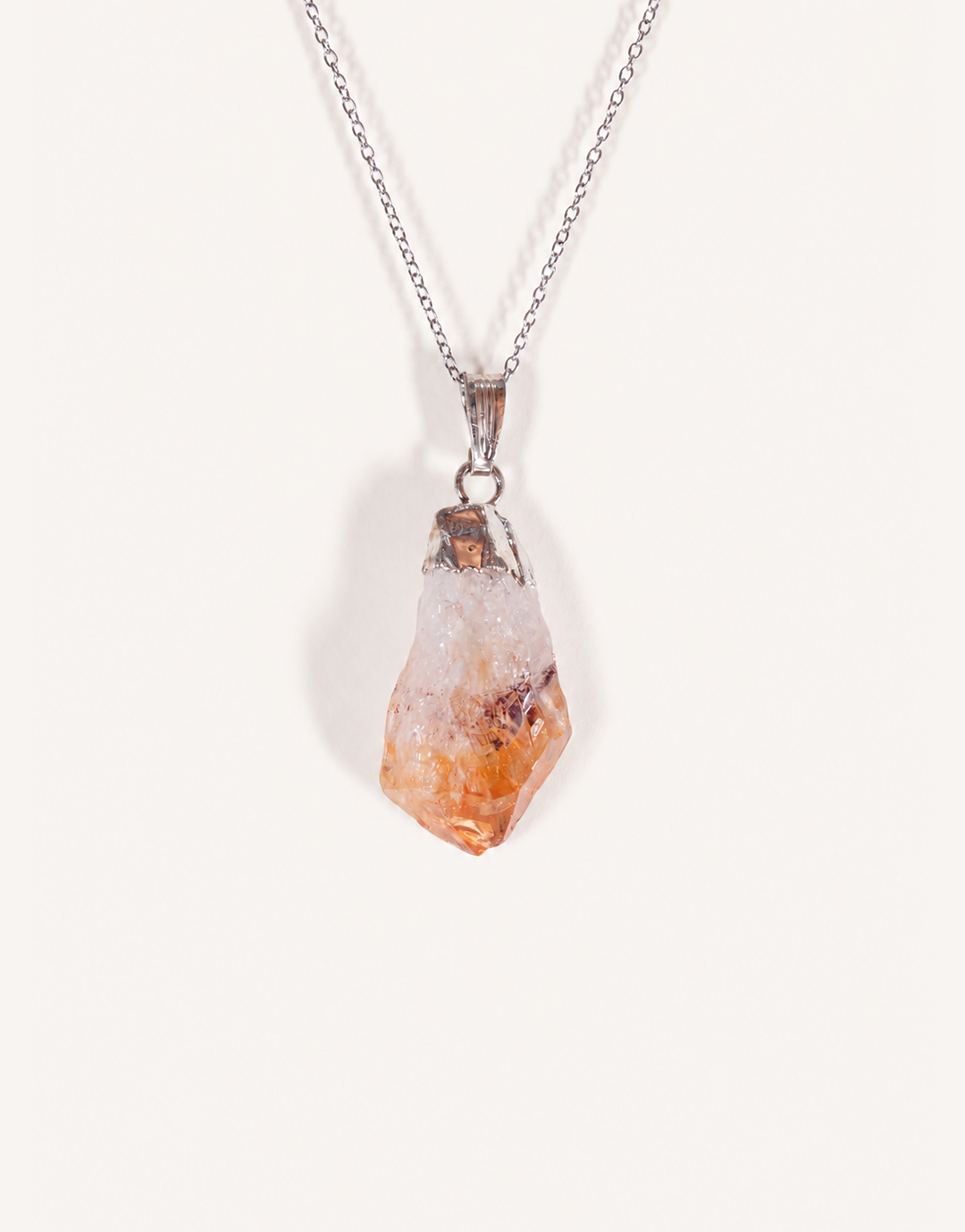 A Natural Raw Citrine Point Pendant showcasing a rough amber-orange and white crystal point on an 18-inch stainless steel chain.