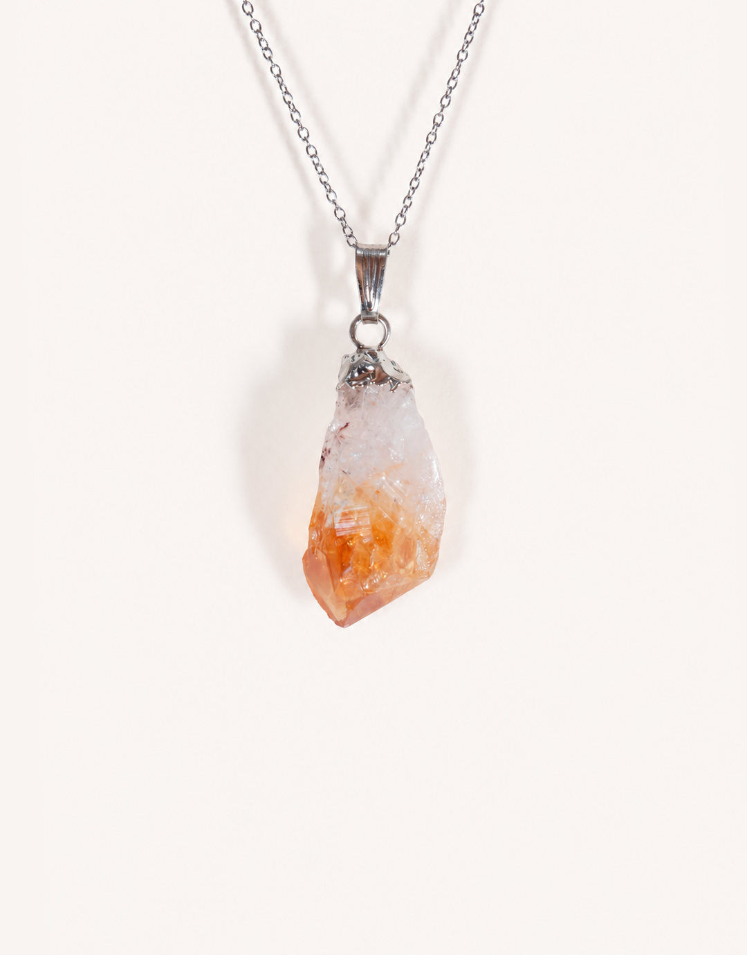 A Natural Raw Citrine Point Pendant showcasing a rough amber-orange and white crystal point on an 18-inch stainless steel chain.