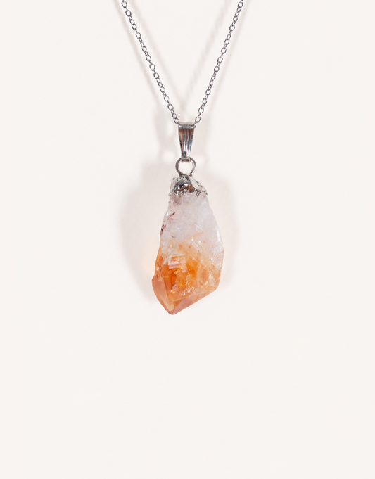A Natural Raw Citrine Point Pendant showcasing a rough amber-orange and white crystal point on an 18-inch stainless steel chain.
