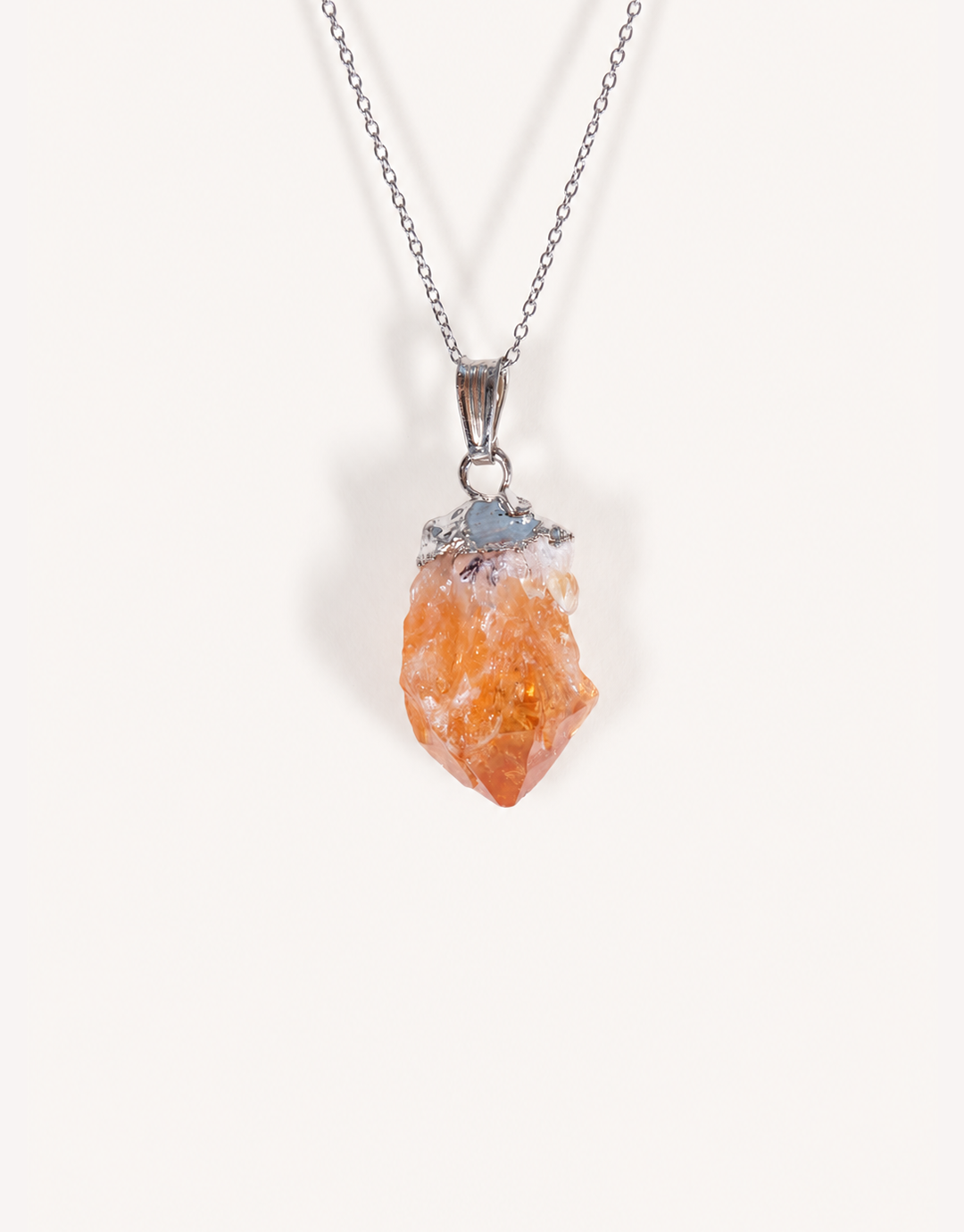 A Natural Raw Citrine Point Pendant showcasing a rough amber-orange and white crystal point on an 18-inch stainless steel chain.