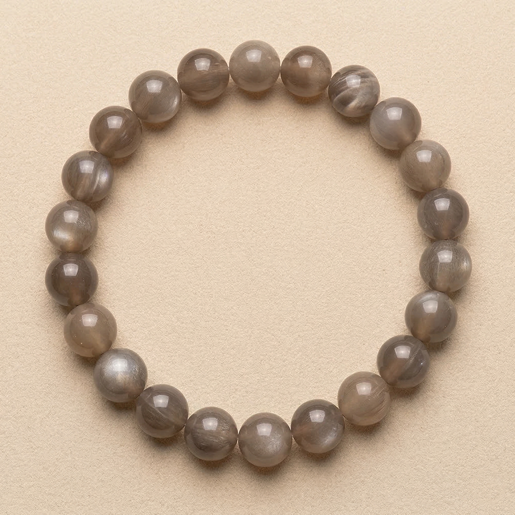 Grey Moonstone beaded bracelet on a beige background