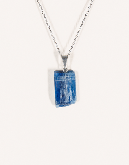 A Natural Kyanite Pendant in deep denim blue hanging from an 18-inch stainless steel chain.