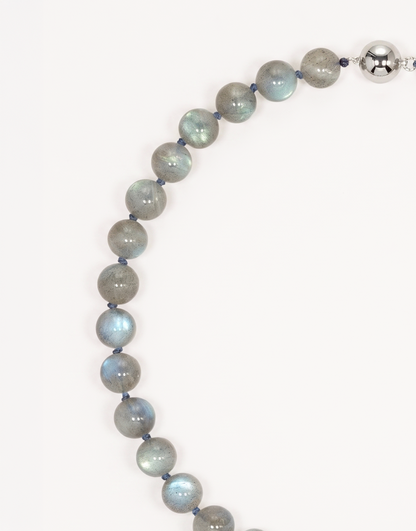 A 16-inch Natural Labradorite Necklace showcasing smooth 10mm charcoal-grey beads with iridescent blue and green labradorescence.
