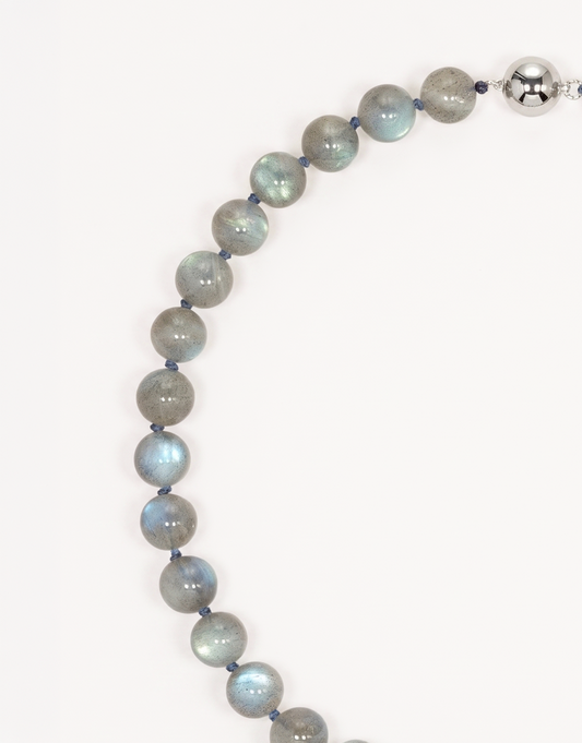 A 16-inch Natural Labradorite Necklace showcasing smooth 10mm charcoal-grey beads with iridescent blue and green labradorescence.