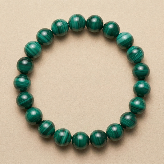 Malachite beaded bracelet on a beige background