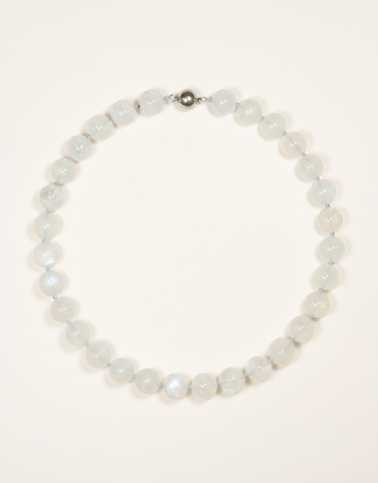 A 16-inch Natural Moonstone Choker showcasing smooth 12mm milky white beads with a soft floating blue flash.