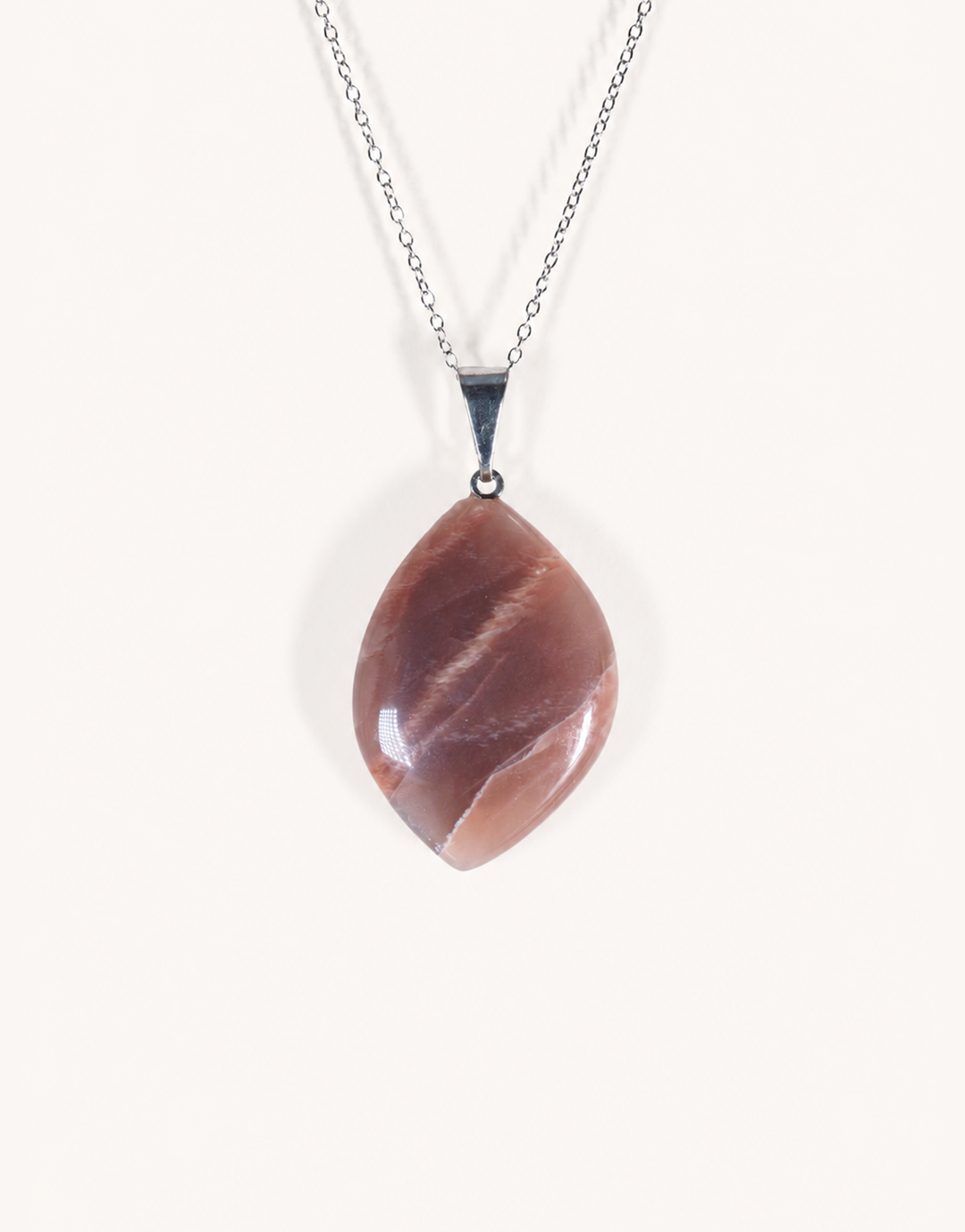 A Natural Peach Moonstone Pendant featuring smooth apricot and dusty-rose tones with a soft sheen on an 18-inch stainless steel chain.