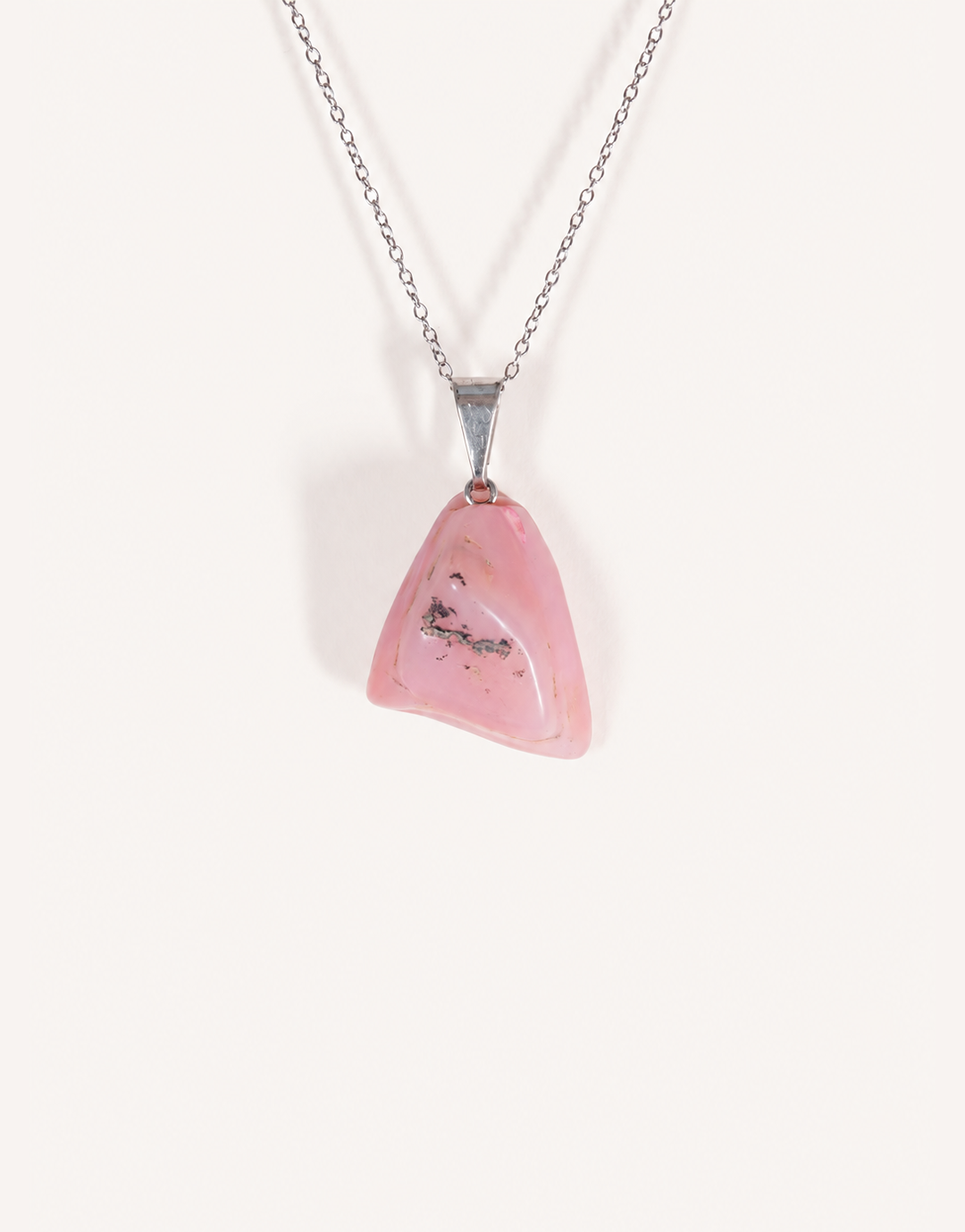 A Natural Pink Opal Pendant featuring a smooth pastel pink tumbled stone on an 18-inch stainless steel chain.