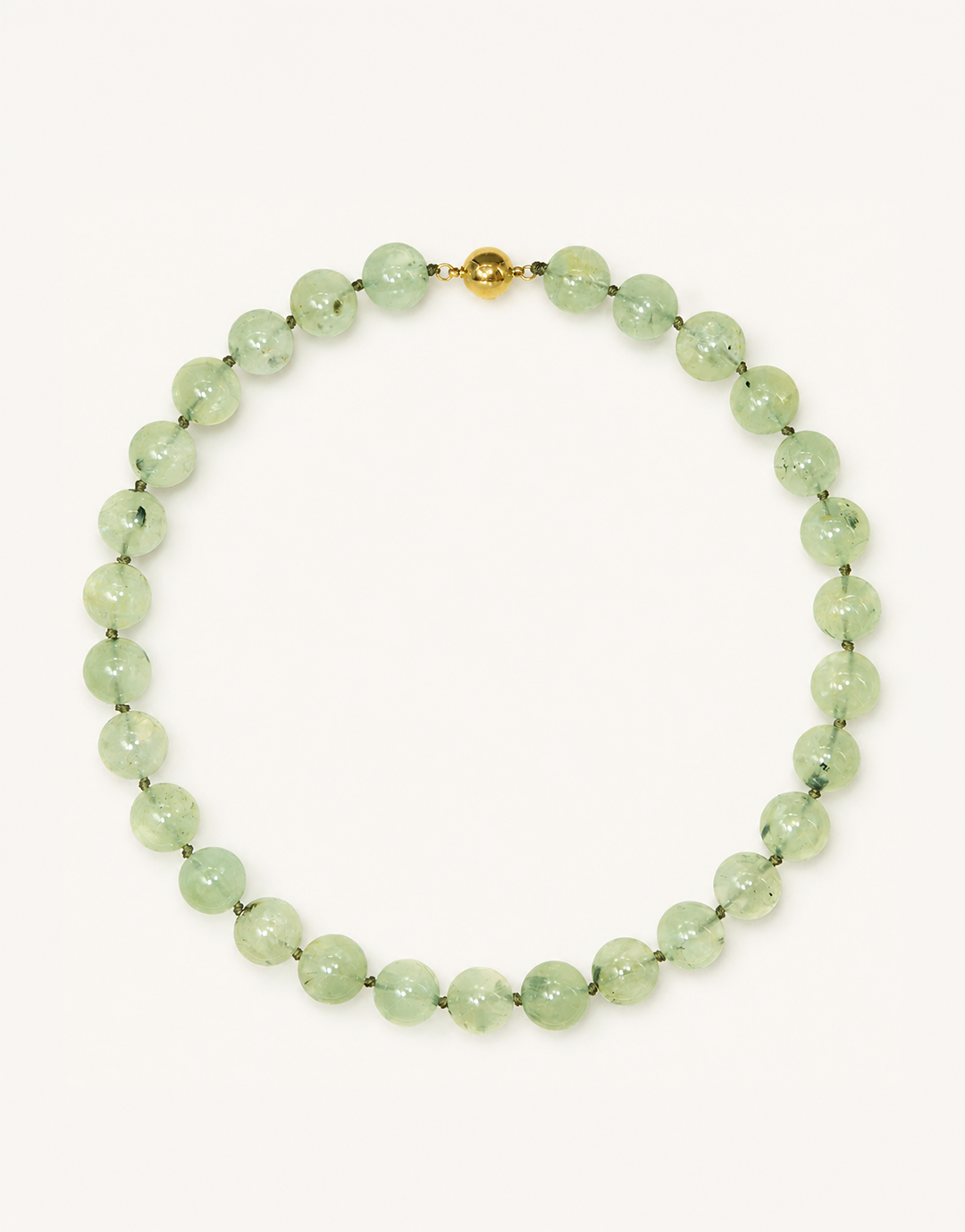 A 16-inch Natural Prehnite Choker featuring polished 12mm light green beads with unique dark tourmaline inclusions.