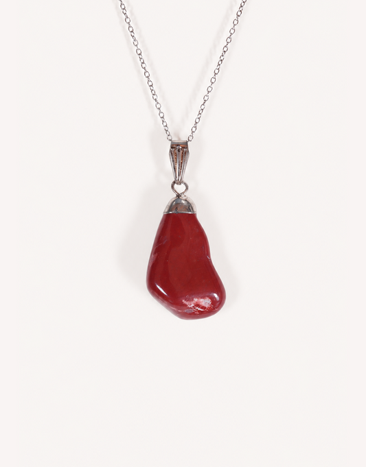 A Natural Red Jasper Pendant displaying a smooth, polished brick-red tumbled stone on an 18-inch stainless steel chain.