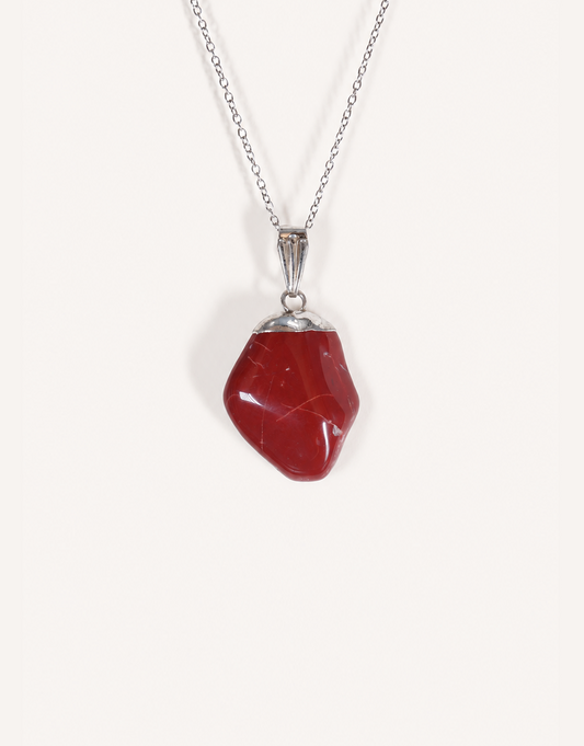 A Natural Red Jasper Pendant displaying a smooth, polished brick-red tumbled stone on an 18-inch stainless steel chain.