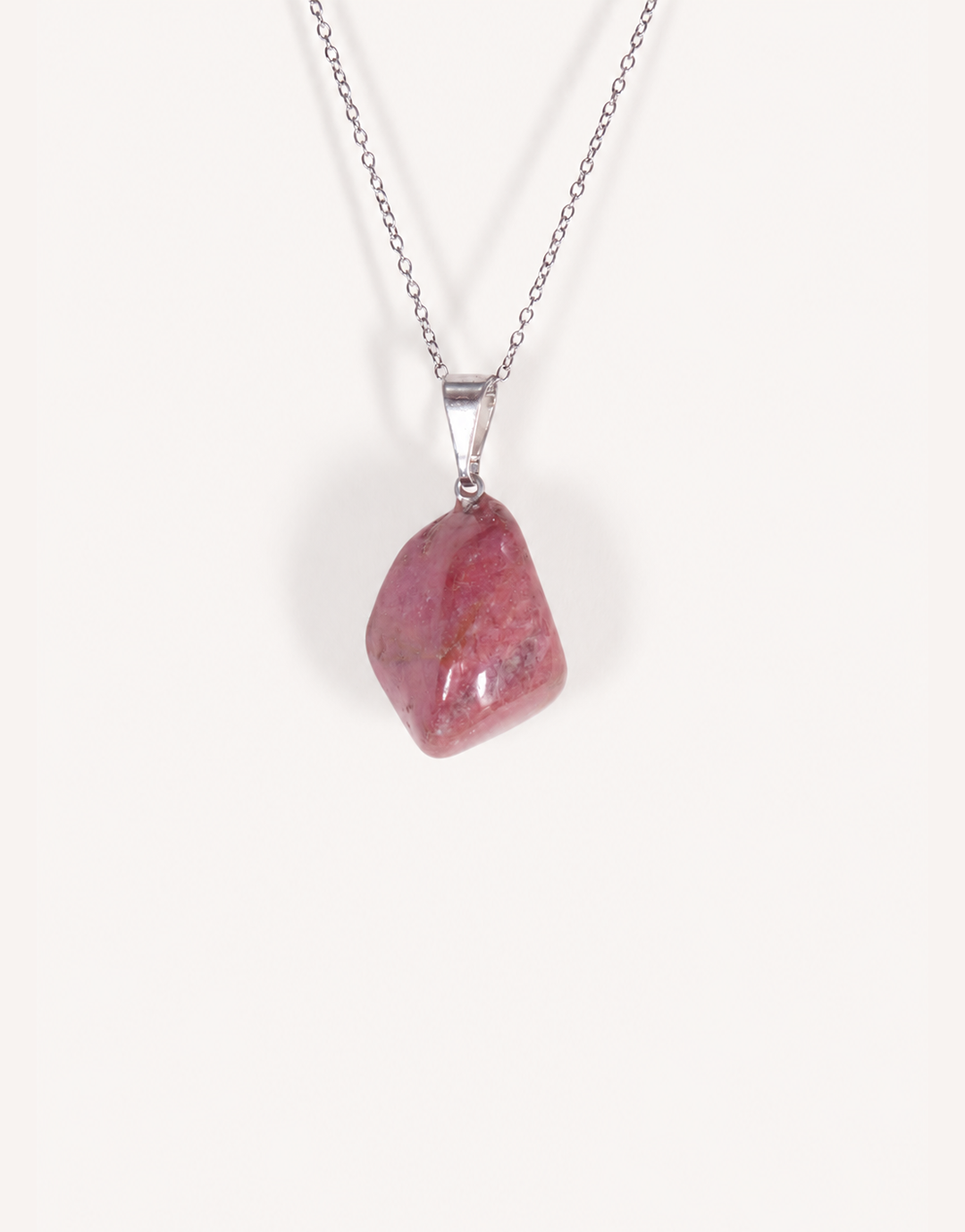 A Natural Rhodonite Pendant featuring a smooth dusty-rose stone with black manganese matrix veins on an 18-inch stainless steel chain.