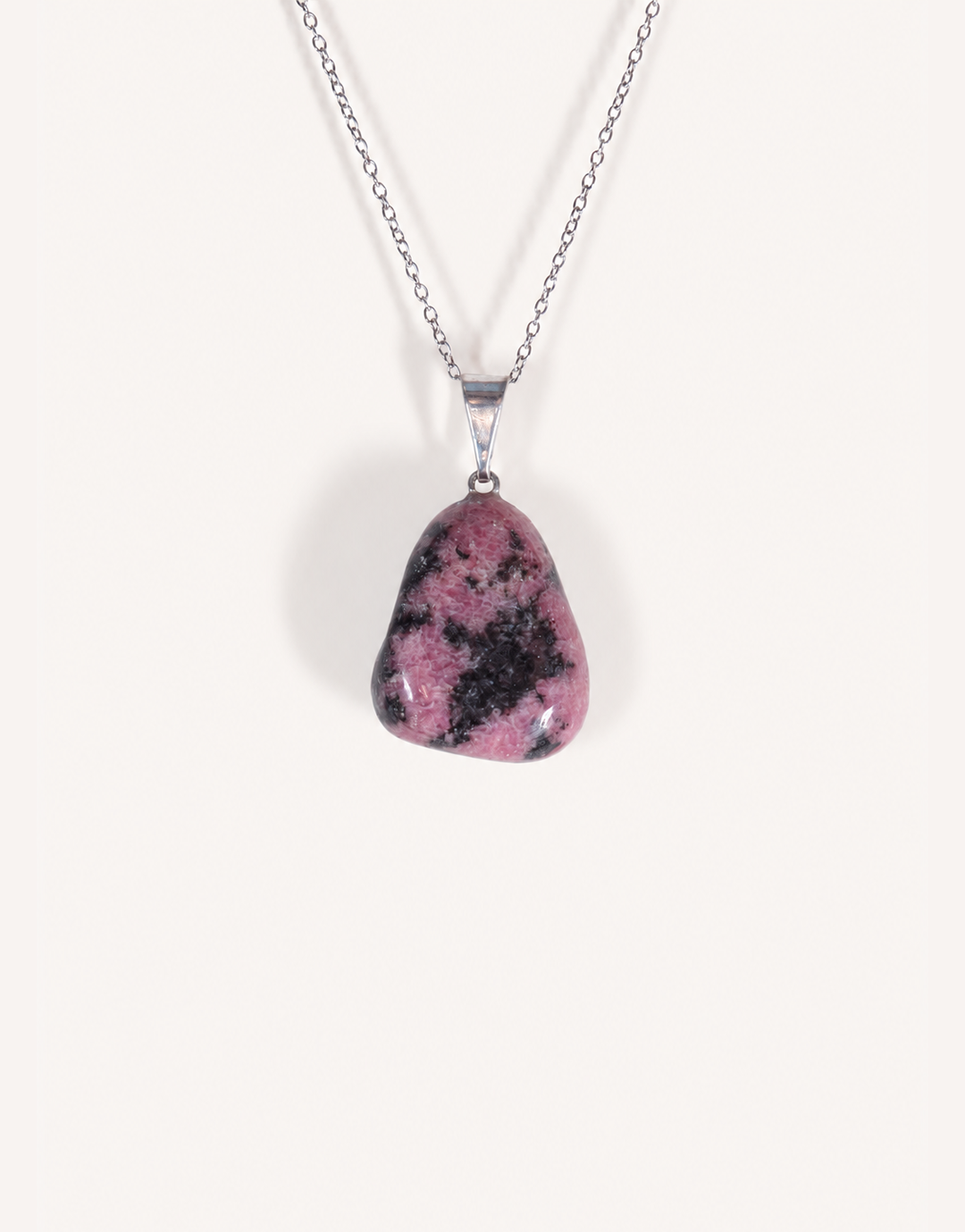 A Natural Rhodonite Pendant featuring a smooth dusty-rose stone with black manganese matrix veins on an 18-inch stainless steel chain.