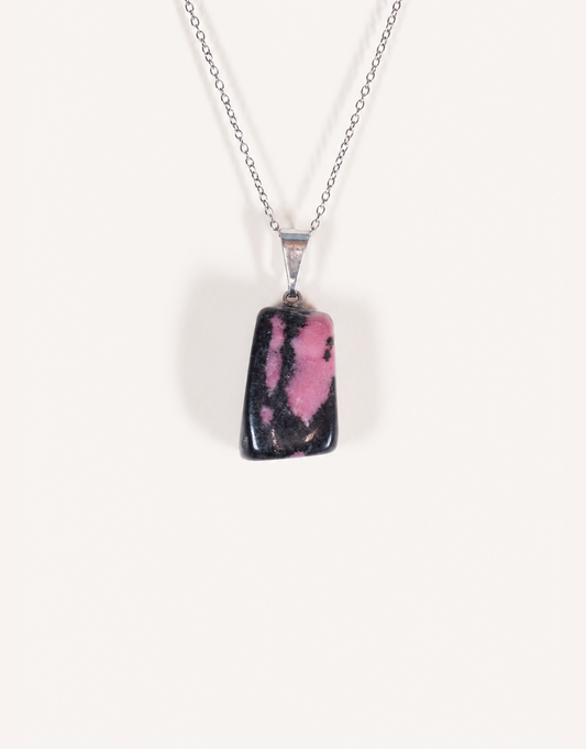 A Natural Rhodonite Pendant featuring a smooth dusty-rose stone with black manganese matrix veins on an 18-inch stainless steel chain.