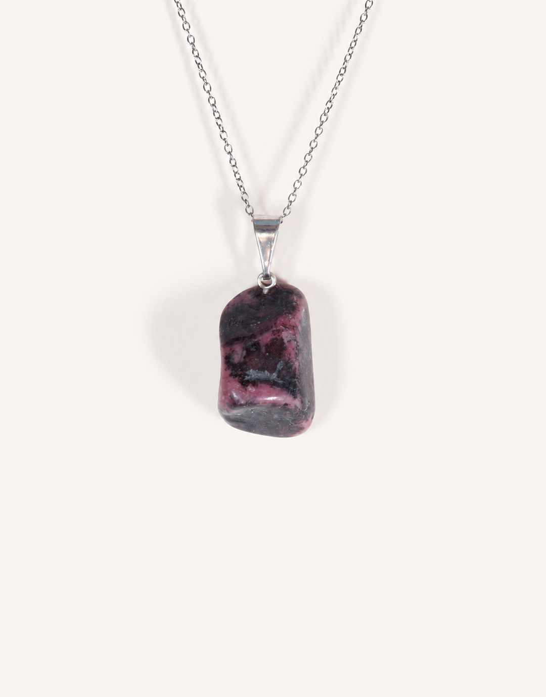 A Natural Rhodonite Pendant featuring a smooth dusty-rose stone with black manganese matrix veins on an 18-inch stainless steel chain.