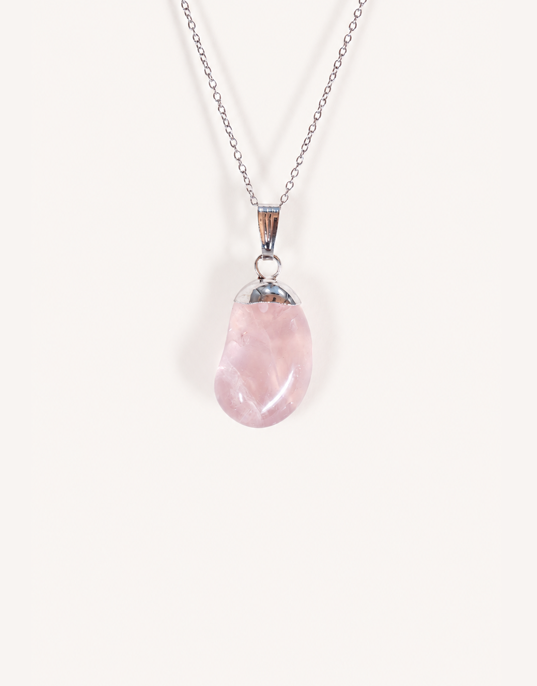 Natural polished rose quartz pendant in soft blush pink on a complimentary 18-inch stainless steel chain.