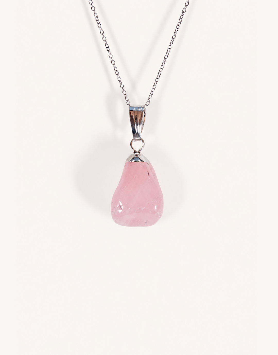 Natural polished rose quartz pendant in soft blush pink on a complimentary 18-inch stainless steel chain.