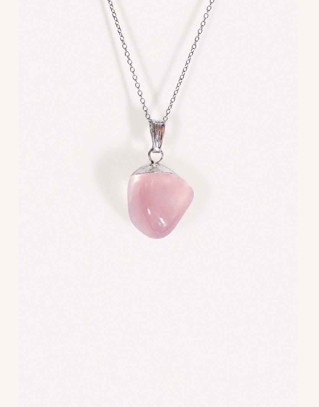 Natural polished rose quartz pendant in soft blush pink on a complimentary 18-inch stainless steel chain.